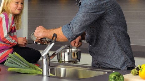 Adult using elbow to turn on Clover Easy Faucet